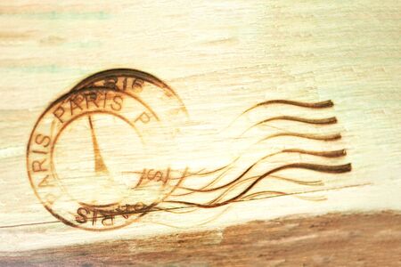 Paris rubber stamp burned on wooden background. Vintage wood backgroundの写真素材