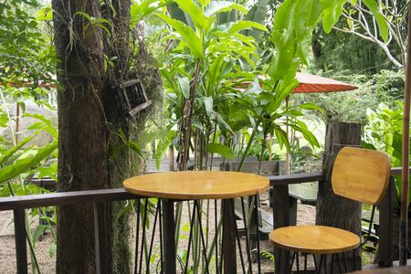 Wooden table  sitting in the gardenの写真素材