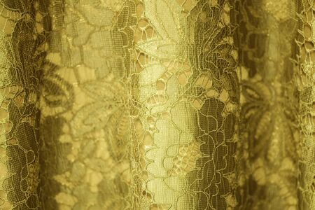 Lace fabric background, gold lace fabricの写真素材