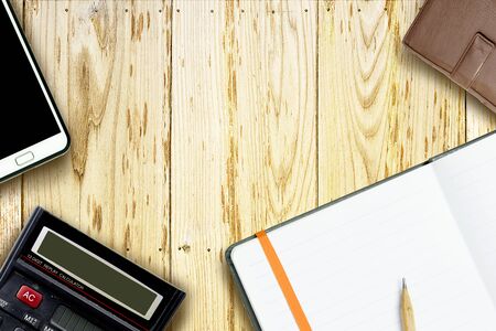 Smart phone, wallet, calculator and brown pencil on notebook. top view. business concept.の写真素材
