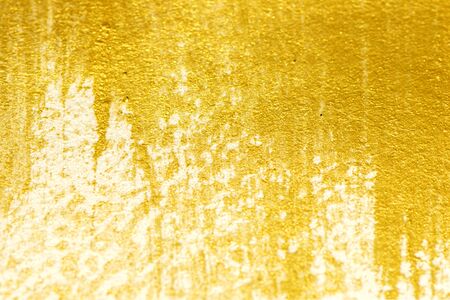 Gold acrylic paint texture on white paper backgroundの写真素材