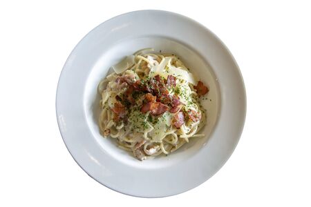Spaghetti Carbonara onion and mushroom cream sauce with ham top view isolated on white backgroundの写真素材