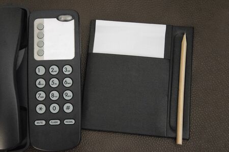 Top view telephone and note for room service, communication themes in hotel or resort.の写真素材