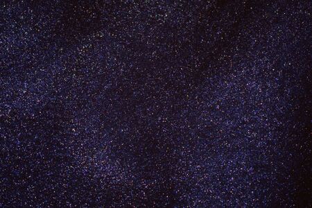 Fantasy bokeh glitter dust on dark magic background.の写真素材