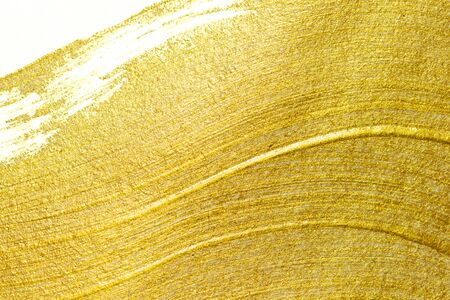 Gold acrylic paint texture on white paper backgroundの写真素材