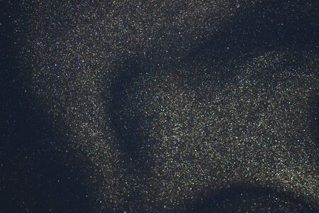 Fantasy bokeh glitter dust on dark magic background.の写真素材