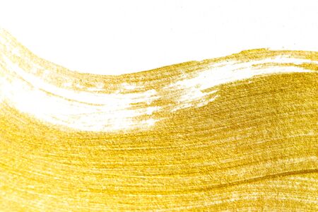 Gold acrylic paint texture on white paper backgroundの写真素材