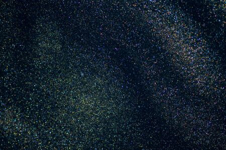 Fantasy bokeh glitter dust on dark magic background.の写真素材