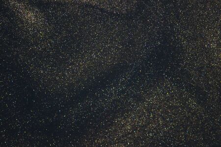 Fantasy bokeh glitter dust on dark magic background.の写真素材