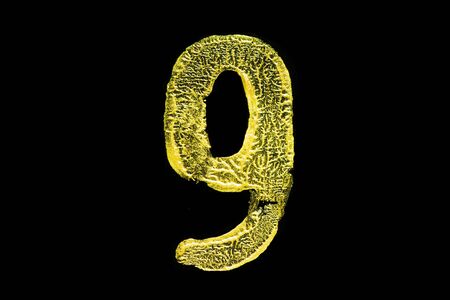 Golden number 9 isolated on black backgroundの写真素材