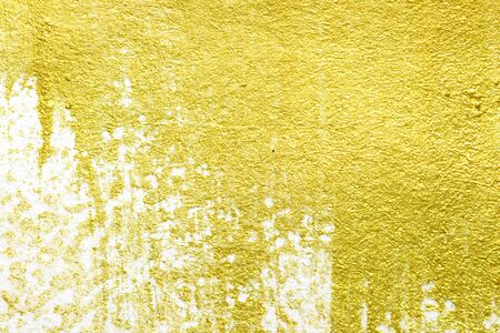 Gold acrylic paint texture on white paper backgroundの写真素材