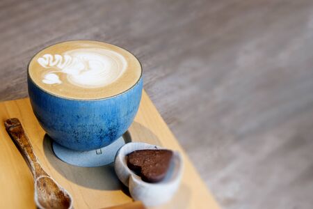 Hot Cappuccino In Cup On Wooden Table With Copy-space. The Latte Art On coffee background.の写真素材