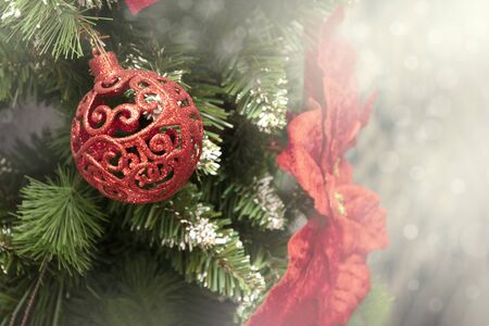 Christmas ball on tree. Closeup on Christmas tree decoration over festive backgroundの写真素材