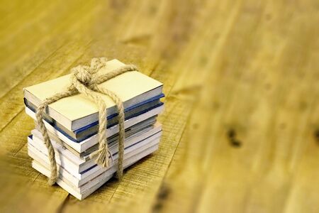 Old book tied with a thick rope on a wooden tableの写真素材
