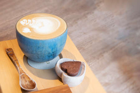 Hot Cappuccino In Cup On Wooden Table With Copy-space. The Latte Art On coffee background.の写真素材