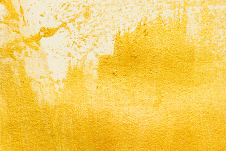 Gold acrylic paint texture on white paper background