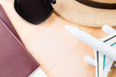 Travel accessories costumes.Passport, glasses, on a wooden.の写真素材