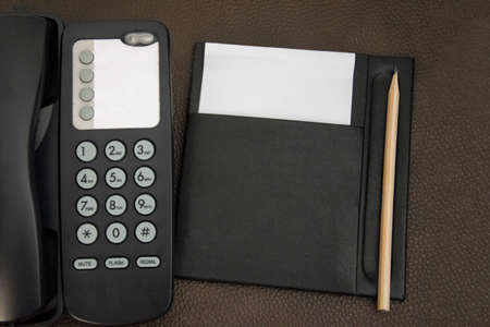 Top view telephone and note for room service, communication themes in hotel or resort.の写真素材