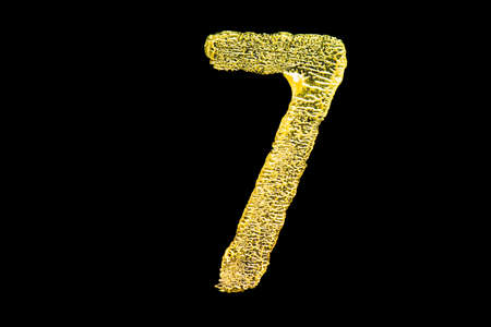 Golden number 7 isolated on black backgroundの写真素材