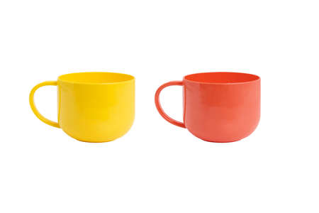 Yellow and red plastic cups on a white background.の写真素材