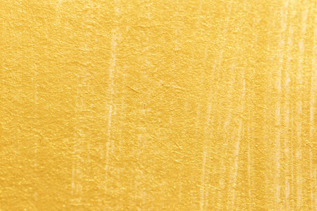 Gold acrylic paint texture on white paper background