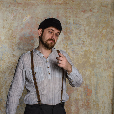 Excited man pointing a great idea adjusting his suspendersの写真素材
