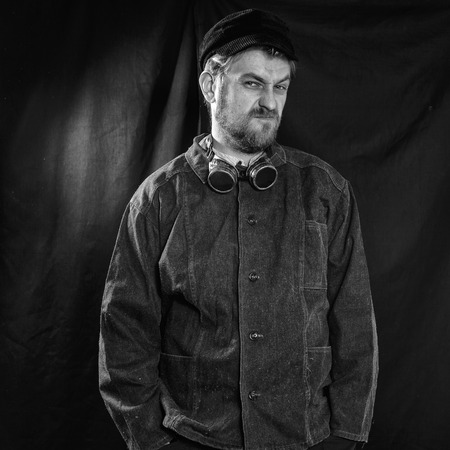 dissatisfied welder in black boilersuit