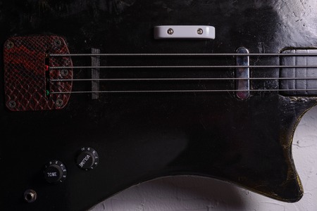 old bass guitar on white backgroundの写真素材