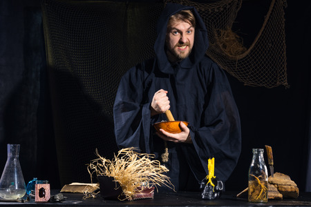 Portrait of a crazy medieval scientist working in his laboratory. Alchemist. Halloween.の写真素材