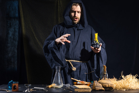 Portrait of a crazy medieval scientist working in his laboratory. Alchemist. Halloween.の写真素材