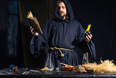 Portrait of a crazy medieval scientist working in his laboratory. Alchemist. Halloween.の写真素材