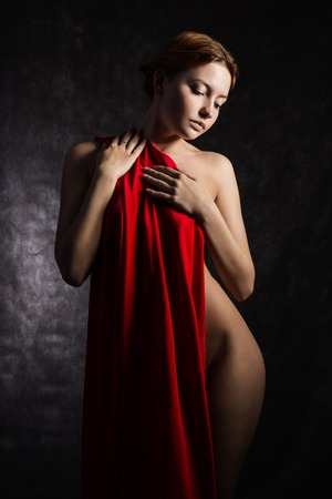 Beautiful woman with red tissue around her waistの写真素材