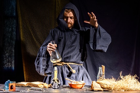 Portrait of a crazy medieval scientist working in his laboratory. Alchemist. Halloween.の写真素材