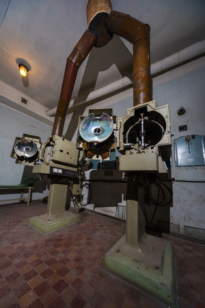 Angled 35mm movie projector images in projecting roomの写真素材
