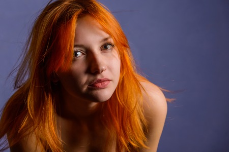 Beautiful smiling woman portrait on blue backgroundの写真素材