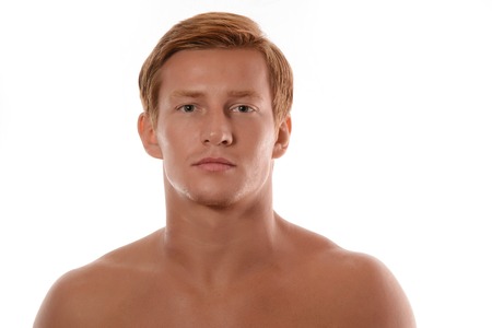 Handsome young man portrait isolated on white background. Muscular teenage guy portrait. Teenager boy face closeupの写真素材