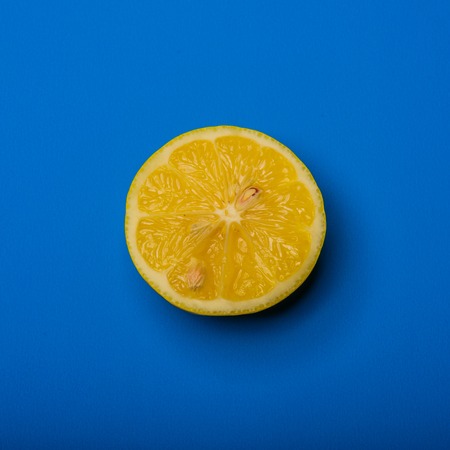A Slice of lemon shot on a blue backgroundの写真素材
