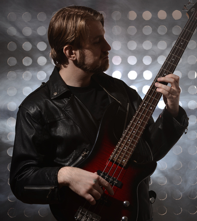 bassist playing a custom made  bass guitar