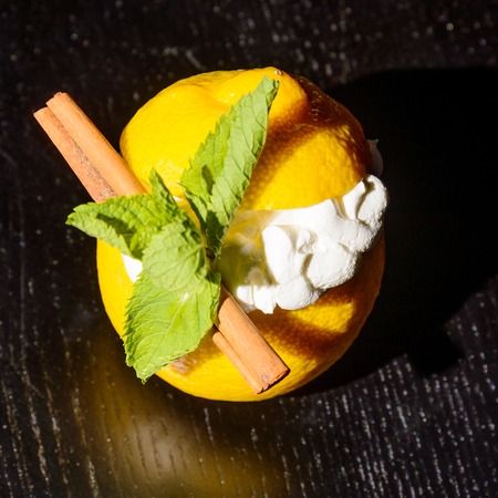 creamy dessert served in lemon halves decorated with smint leaves
