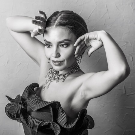 Black and white portrait of beautiful woman  in black dress with  necklaceの写真素材