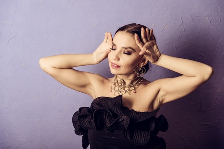 beautiful young woman in a black sexy dress.luxury.beauty brunette with a necklaceの写真素材