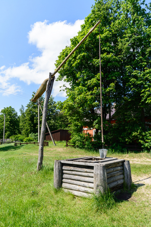 picturesque rural landscape with a well a crane.の写真素材