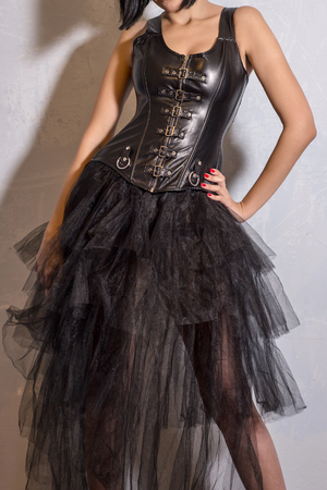 Slim sexy woman with hourglass figure in black leather corset, studio shotの写真素材