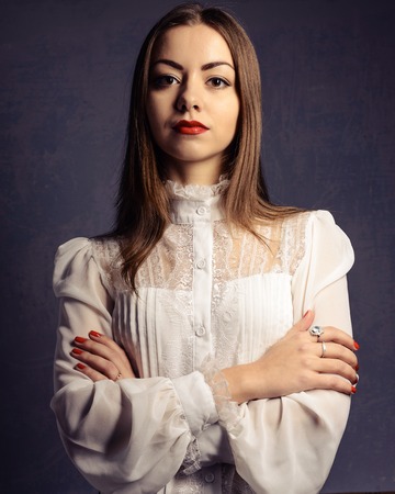 Beautiful girl in a white blouse. Business lady.の写真素材