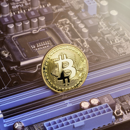 Golden Bitcoin coins on Motherboard, miner with circuit board, pool Cryptocurrency - Imageの写真素材