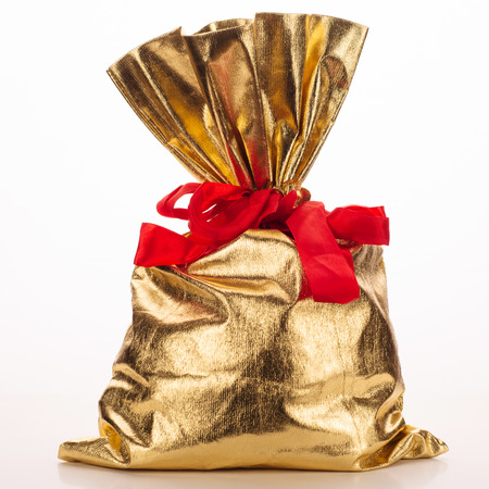 Golden bag of gifts isolated on a white background. Studio photography - Imageの写真素材