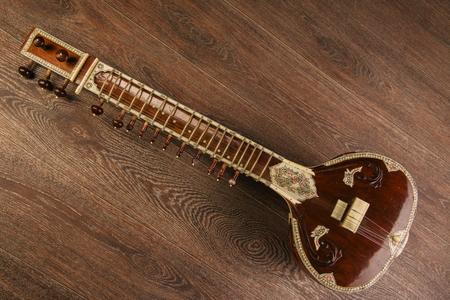Indian musical instrument sitar lying on the wooden floor- imageの写真素材