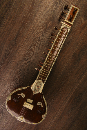Indian musical instrument sitar lying on the wooden floor- imageの写真素材