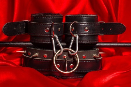 Close up bdsm outfit. Bondage, kinky adult sex games, kink and BDSM lifestyle concept with a pair of...
