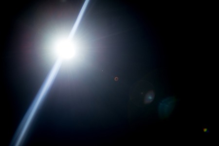 Flash of a distant abstract star. Abstract sun flare. The lens flare is subject to digital...